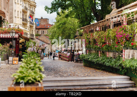 Belgrade, Serbia - June 16, 2018. Flowers in pots on historic place Skadarlija with trees, cafes, cobbled lanes and alleys in downtown. Bohemian stree Stock Photo