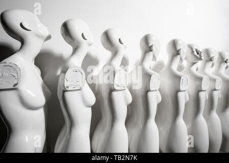 Wide angle Photo of Plastic Woman Mannequins Standing in The Line, With One Looking to Another Direction then the Others Stock Photo