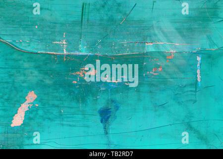 Inverted image of scratch marks and peeling blue paint on metal wall Stock Photo