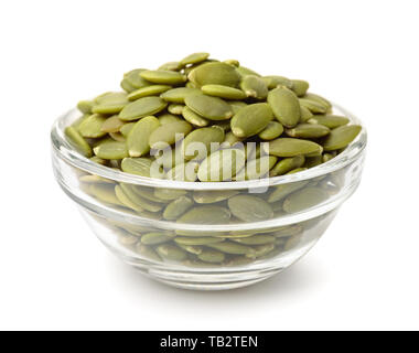 Glass bowl of pumpkin seeds isolated on white Stock Photo