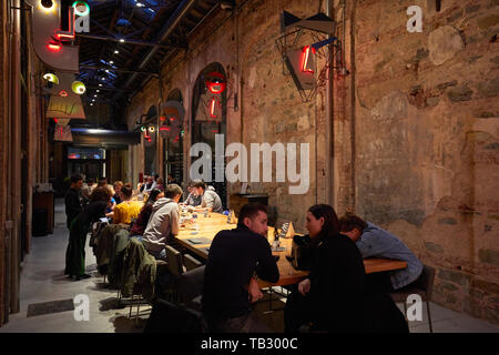 TURIN, ITALY - NOVEMBER 3, 2018: Ogr, Officine Grandi Riparazioni cafe interior with people, evening in Turin, Italy. Stock Photo