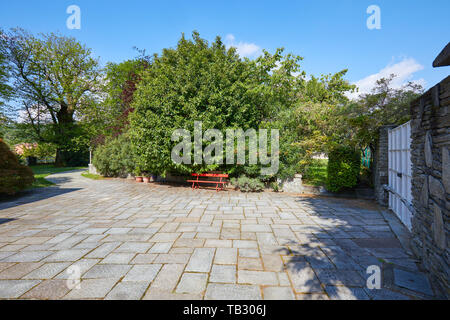 Villa court, white gate and garden in a sunny summer day, Italy Stock Photo