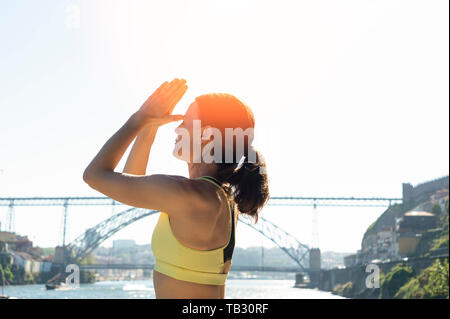 woman meditating in the sun, third eye yoga pose, healthy lifestyle