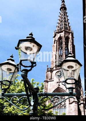 street lamp in retro style in front of neo-gothic church Stock Photo