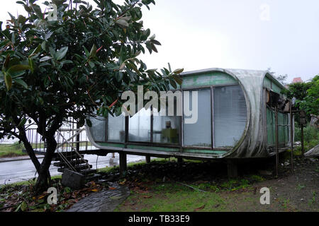 Abandoned Sanzhi UFO house in the neighborhood of Wanli region home to the  last pod of Futuro “UFO” houses in Sanzhi District, New Taipei, Taiwan. The  Sanzhi pod houses or Sanzhi Pod