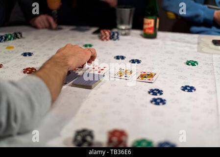 Texas hold 'em poker game, the dealer reveals the community cards after the bets have been placed. Stock Photo