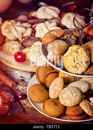 Oatmeal cookies, crispy wafer rolls on tier cake stand Stock Photo