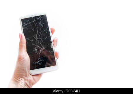 Mobile smartphone with broken glass screen in woman hand isolated on white. copyspace fo text. Service, repair and technology concept. Stock Photo