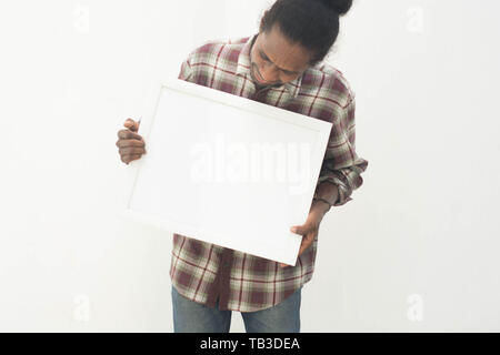 young black man pointing white board with isolated background in white Stock Photo