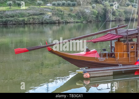 Pinhao / Portugal - 04 16 2019 : Front view of a recreational and leisure boats for tourism on river Douro, Port wine route, hills with vineyards as b Stock Photo