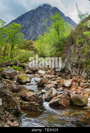 Waterfall on River Coupall, Highlands of Scotland.  The mountain in the background is Buachaille Etive Mor.  The waterfalls are in Glen Etive near Glen Coe and Rannoch Moor in the central highlands of Scotland close to the West Highland Way long distance footpath Stock Photo