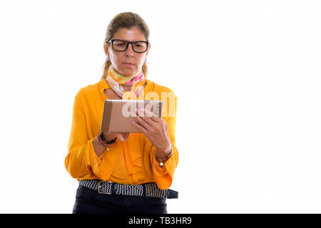 Studio shot of mature beautiful businesswoman using digital tabl Stock Photo