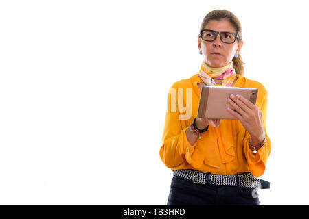 Studio shot of mature beautiful businesswoman using digital tabl Stock Photo