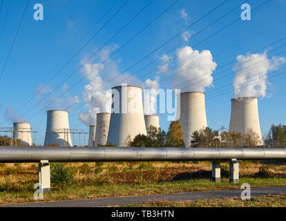 Power plant smoking chimney at sunset, environmental pollution concept. Stock Photo