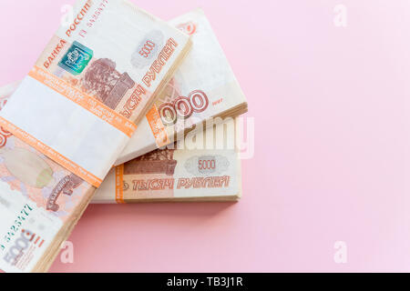 Stack of 5000 rubles packs isolated on pink. The concept of wealth, profits, business and finance. Stack money in the five thousandth bills banknotes Stock Photo