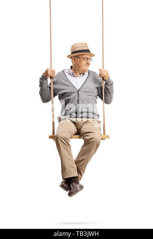 Full length portrait of a mature gentleman sitting on a swing and looking to the side isolated on white background Stock Photo