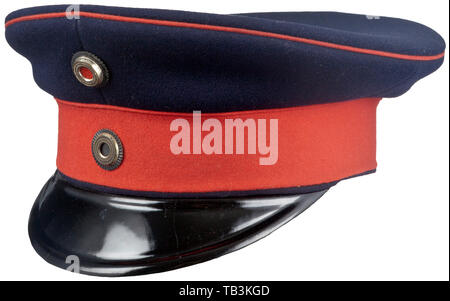 An Imperial German officer visor cap for Prussian Regiments, Dark blue cap  body, red band, red piping, black visor, officer Prussian and national  cockades, brown leather sweatband with fine white silk lining.