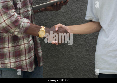 diffrent color handshake, black and yelow handshaking, white and black handshake Stock Photo
