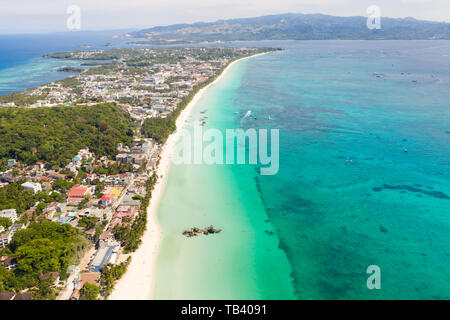 The coast of the island of Boracay. White beach and clear sea. Seascape with a beautiful coast in sunny weather. Residential neighborhoods and hotels  Stock Photo