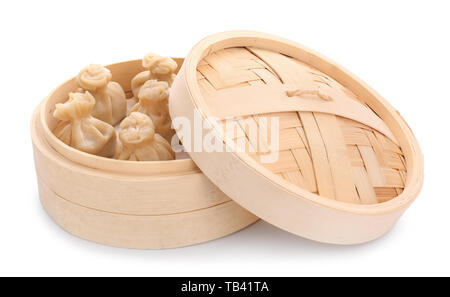 Bamboo steamer with tasty dumplings on white background Stock Photo