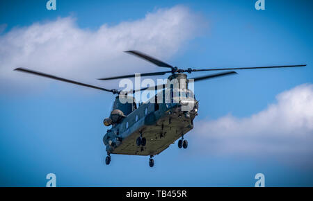 RAF Chinook Helicopter in Flight with blurred blades at the Duxford Air Show Stock Photo