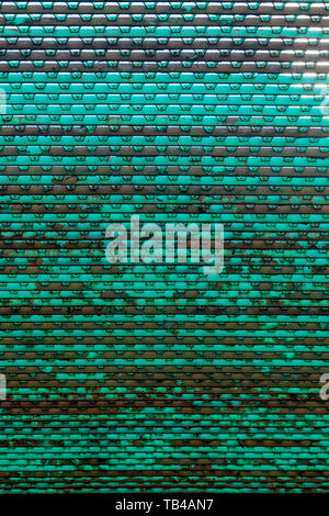 Looking at an old dirty metal grid from below Stock Photo