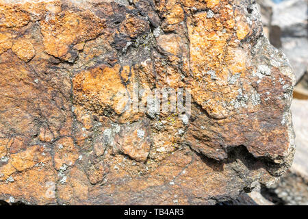 Close-up of a rock texture with small patches of Lichen on the surface Stock Photo
