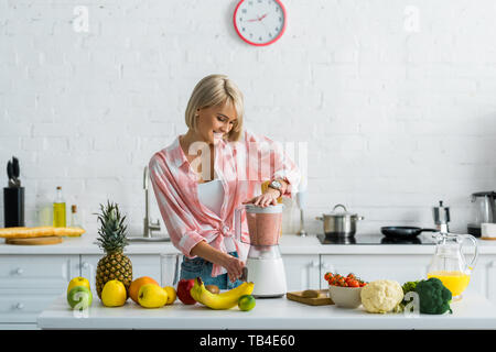 Premium Photo  Man pouring nondiary milk in blender with cut bananas when  making smoothie