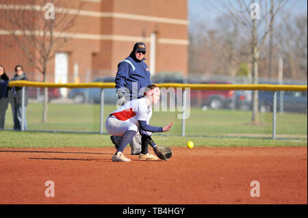 Second baseman fielding a ground ball prior to throwing on to first base to retire the batter. USA. Stock Photo