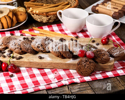 Oatmeal chocolate cookies with coffee grains and cherry. Sun flare Stock Photo