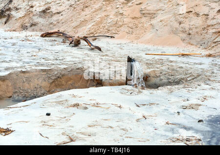 water from sewer pipe, wastewater on the seashore Stock Photo