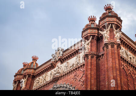 Architectural close-up of the top of the monumental red brick Arch of Barcelona in Spain Stock Photo