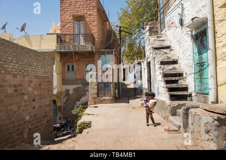 The Blue City, Jodhpur / India - 03 27 2019, Beautiful colorful buldings and architecture.Popular tourist destination in Rajasthan.Children on street. Stock Photo