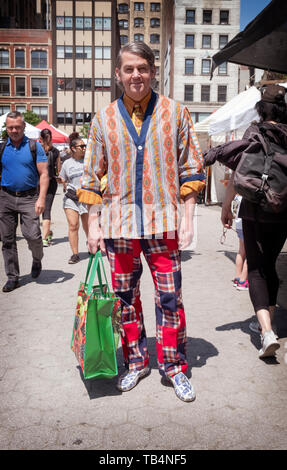 Posed portrait of a shopper in Union Square Park with his own individual personal fashion Style. In Manhattan, New York City. Stock Photo