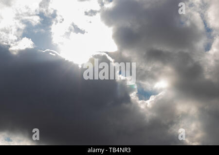 Heavy dark clouds with sunlight highlights and deep shadows Stock Photo
