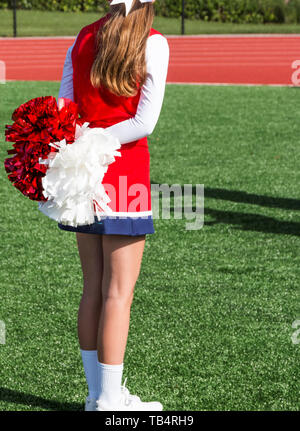 Portrait of cheerleader ( 8-9 years) holding pom-pom Stock Photo - Alamy