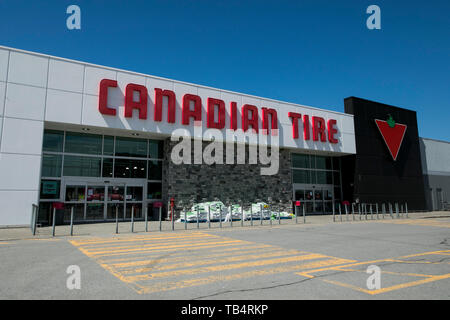 A logo sign outside of a Canadian Tire retail store location in Montreal, Quebec, Canada, on April 21, 2019. Stock Photo