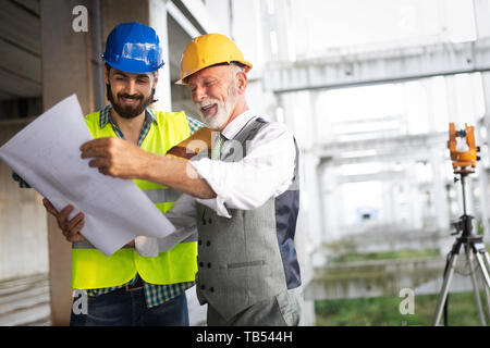 Team of business people in group, architect and engeneer on building site check documents Stock Photo