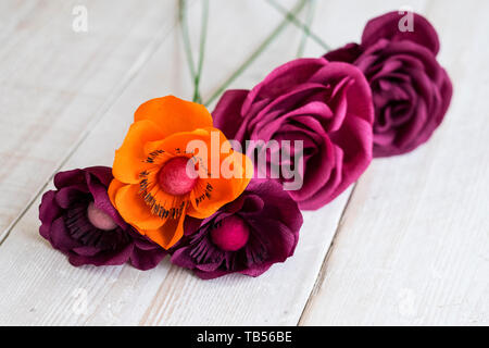 dark purple and orange paper or fabric flowers Stock Photo