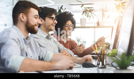 Group of young programmers developing data code, working together in modern office, panorama with free space Stock Photo