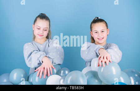 Having fun concept. Balloon theme party. Girls best friends near air balloons. Start this party. Birthday party. Happiness and cheerful moments. Carefree childhood. Sisters organize home party. Stock Photo