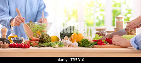 Cooking, food and home concept - close up of female hand cutting pepper on cutting board at home Stock Photo