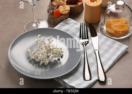 Beautiful table setting on grey background Stock Photo