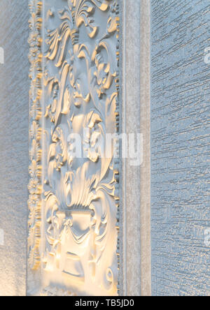 a decorative element from a plaster molding on the wall of the facade Stock Photo