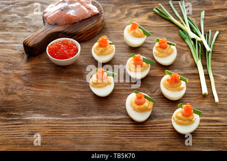 Tasty deviled eggs on wooden table Stock Photo