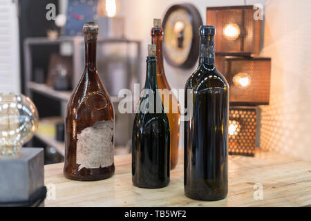 Four Empty Dark Glass Bottles with Corks. Stock Photo