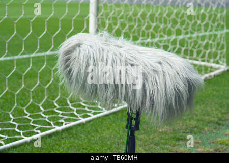 Professional sport microphone on a soccer field behind the net Stock Photo