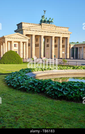 The famous Brandenburg Gate in Berlin with a small pond Stock Photo