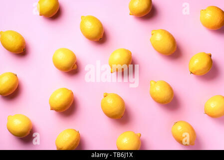 Food pattern with lemons on pink paper background. Top view. Summer concept. Vegan and vegetarian diet. Stock Photo