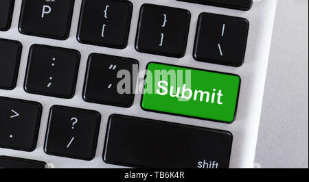 Word Submit on green button of computer keypad Stock Photo